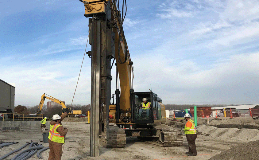 construction workers and drill rig