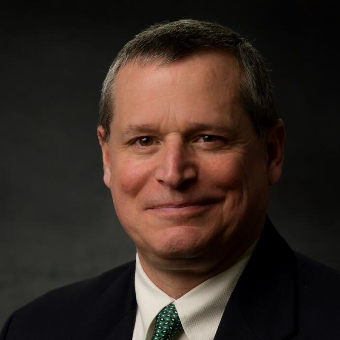 man in black suit with green tie