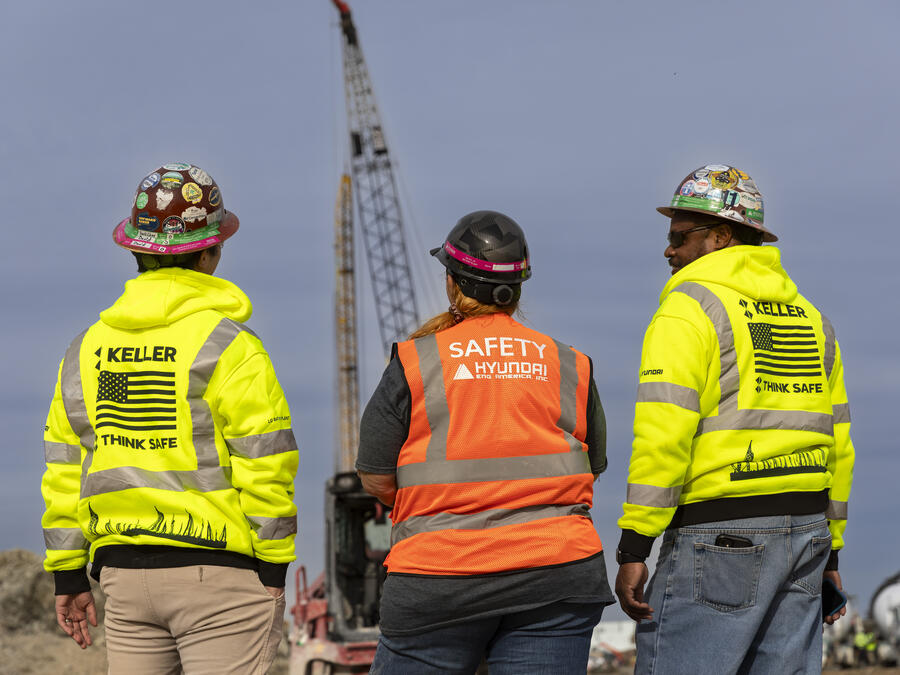 Three people on construction site