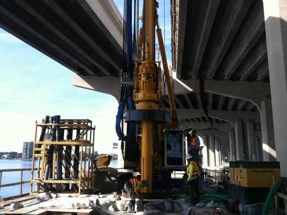 Installing drilled shafts between two bridges